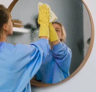 cleaning a bathroom mirror